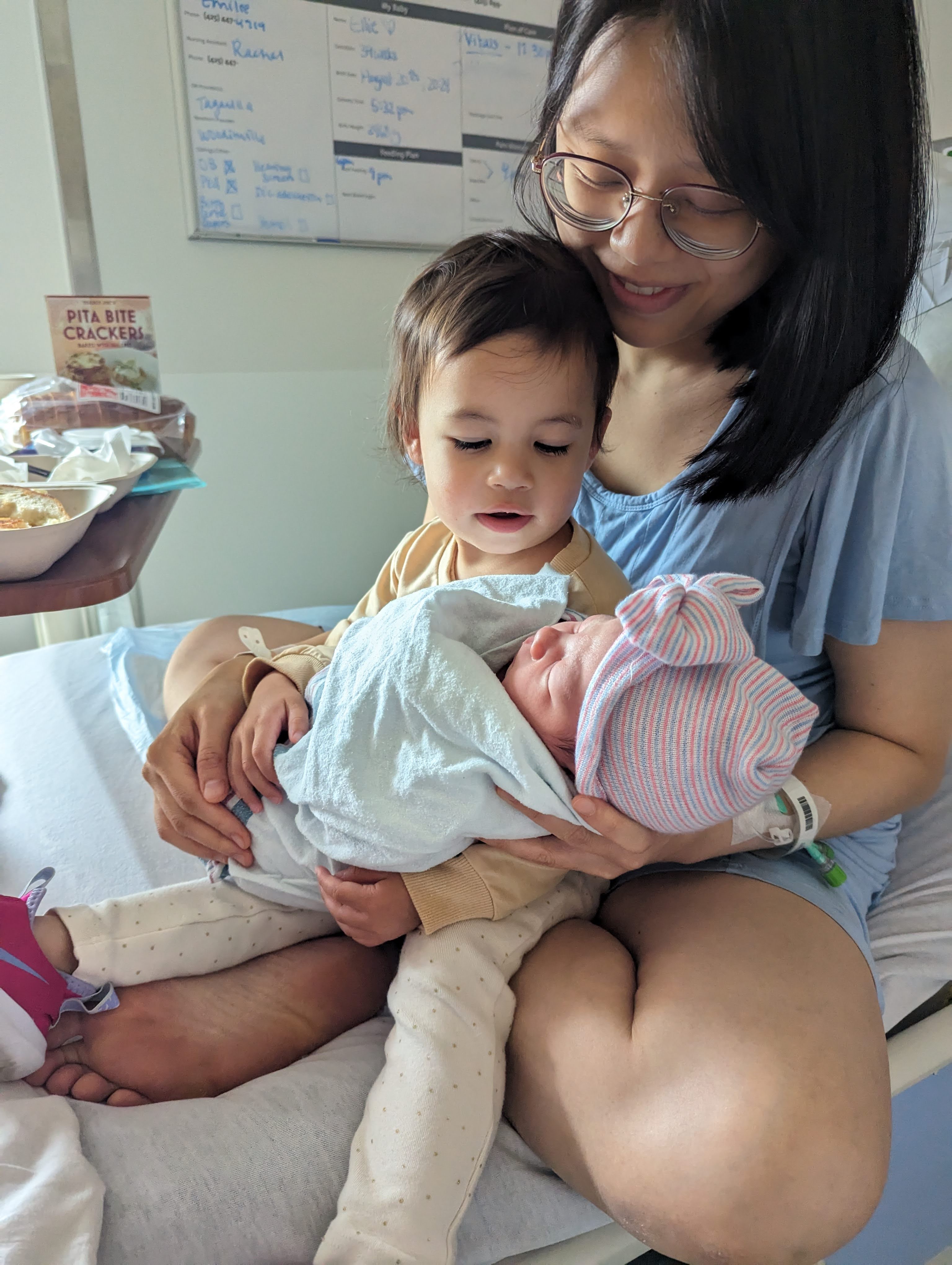 Maya holding ellie for the first time